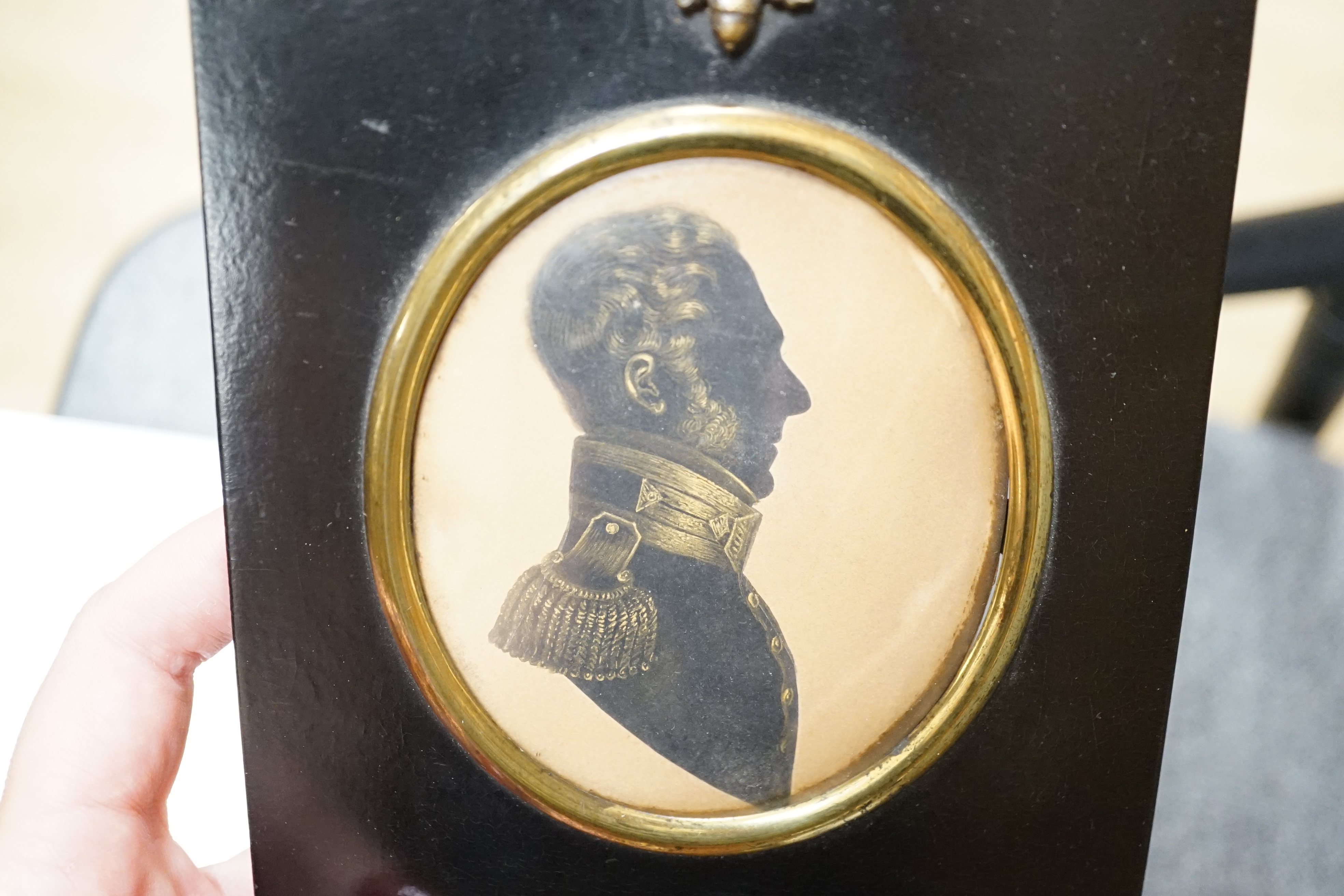 19th century, cut paper and bronzed silhouette of Capt H.Cardew, late Royal Engineers, 8.5 x 7cm, housed in an ebonised frame. Condition - fair